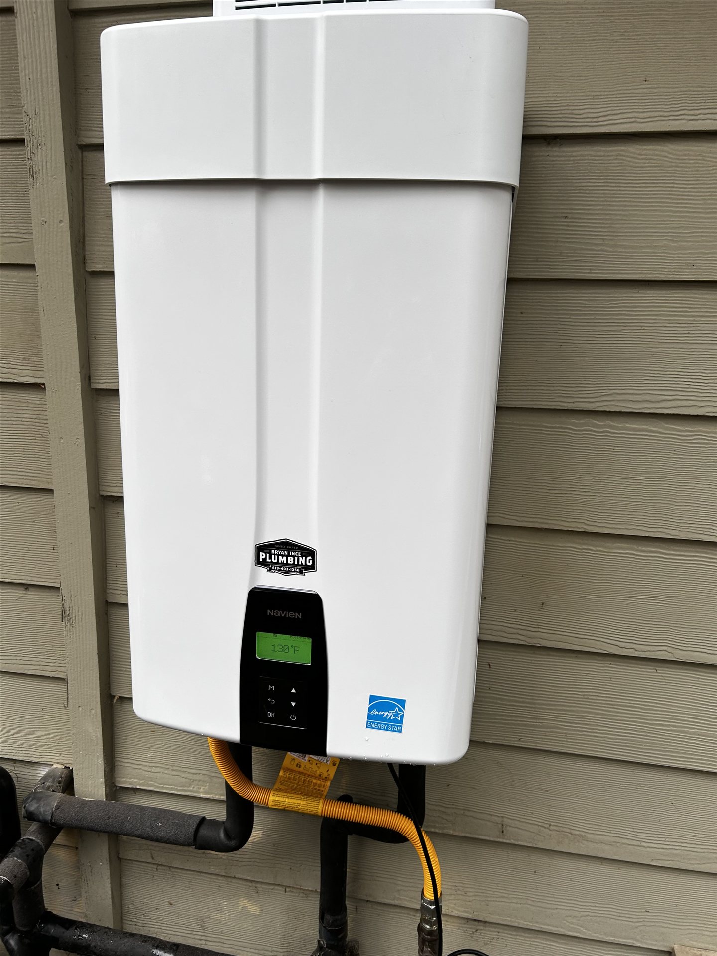 Bryan Ince Plumbing technician installing a Navien tankless water heater